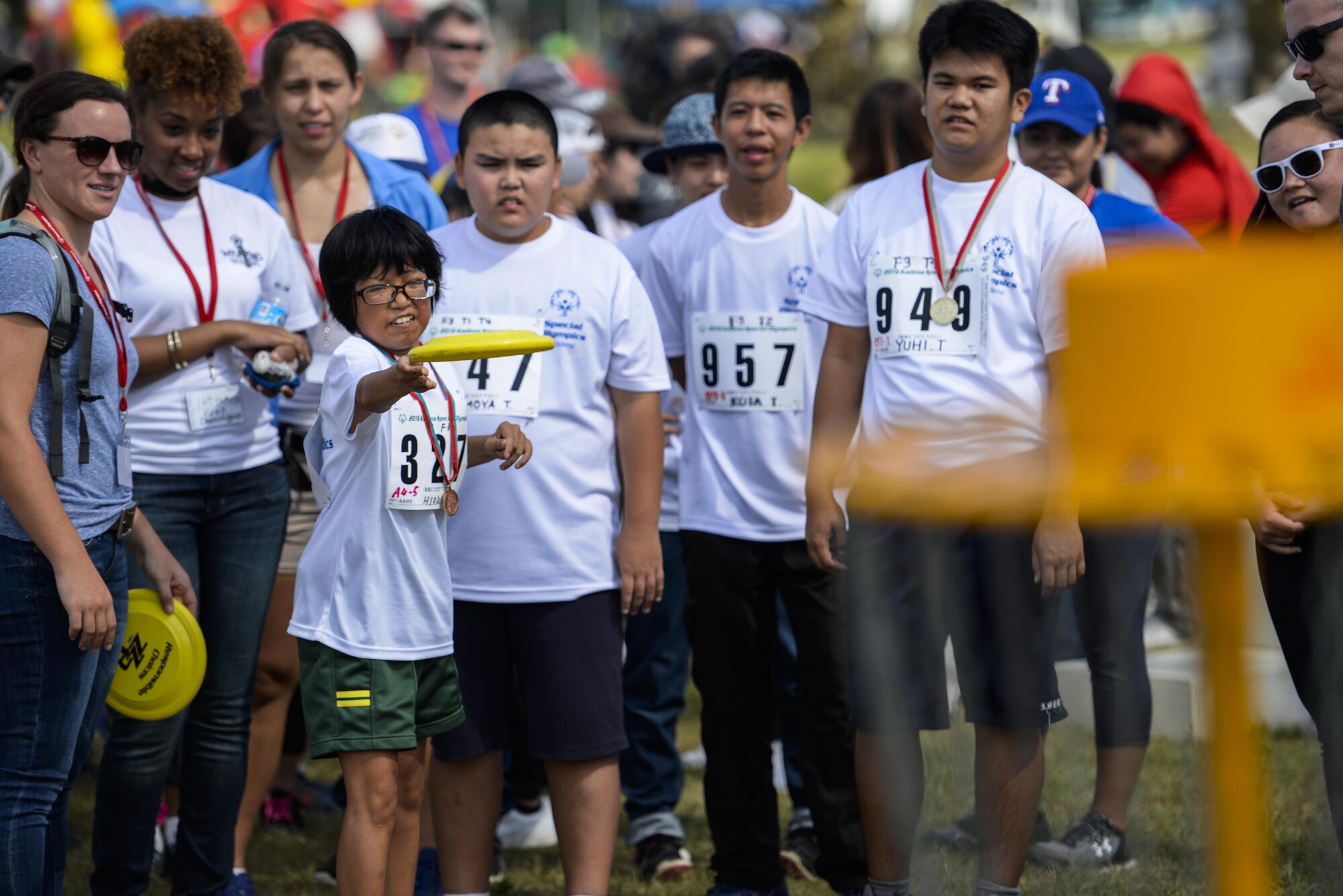 Hiori Moramizato, a Kadena Special Olympic athlete, competes in the Frisbee toss challenge with other athletes looking on during the Kadena Special Olympics Nov. 5, 2016, at Kadena Air Base, Japan. KSO began in 2000 with approximately 400 athletes and 600 volunteers as an 18th Wing community goodwill initiative and has since grown to hold more than 1000 competing athletes strengthening U.S.-Okinawa relationships. (U.S. Air Force photo by Senior Airman Stephen G. Eigel/released)