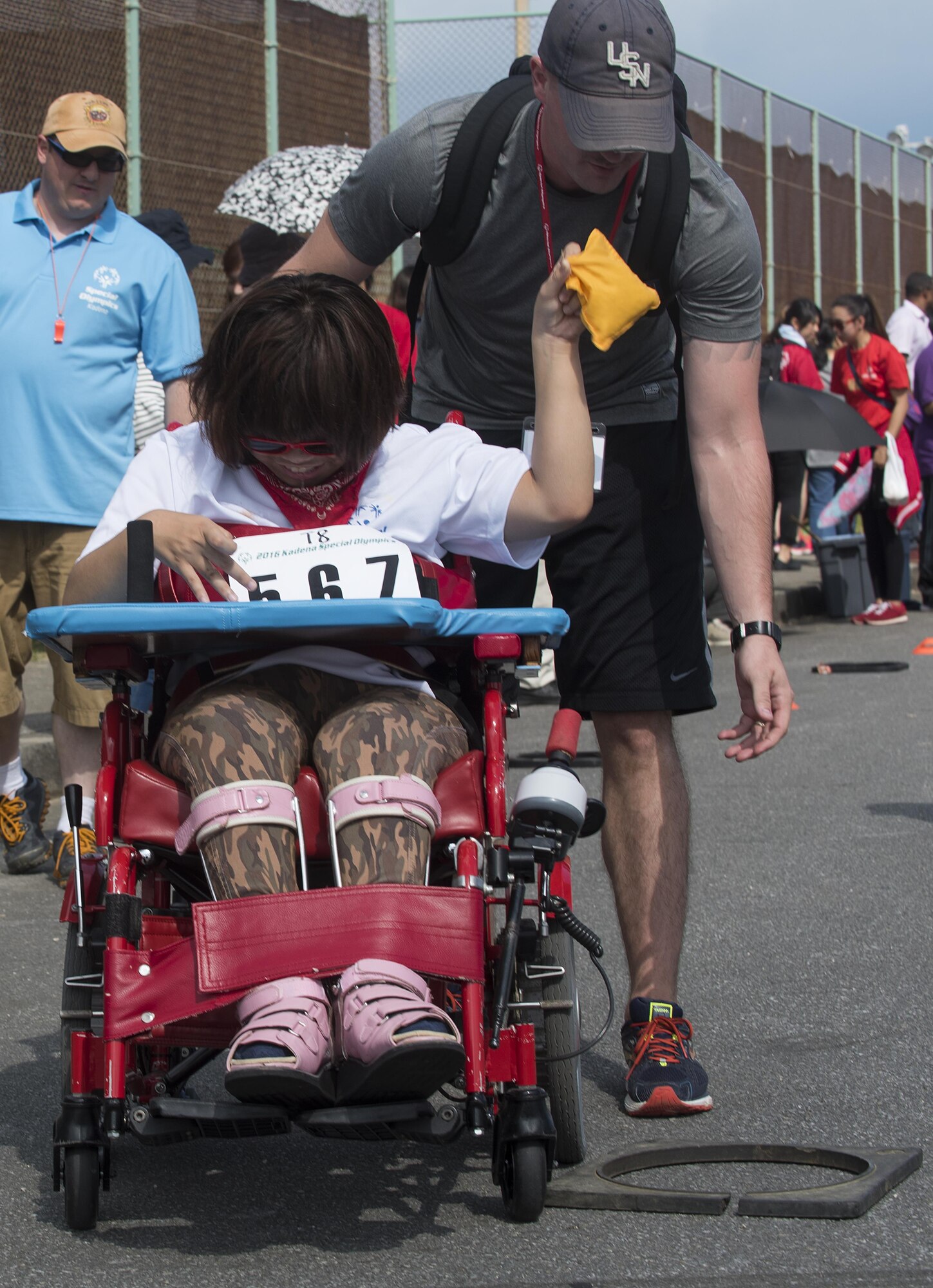 Ayami Goya, Kadena Special Olympics athlete, throws a bean bag at the target during a wheelchair race Nov. 5, 2016, at Kadena Air Base, Japan. The Kadena Special Olympics is the largest community outreach of the year in the Pacific Theater partnering nearly 1,000 volunteers with almost 900 special needs athletes who compete in more than 50 events. (U.S. Air Force photo by Airman 1st Class Corey M. Pettis/Released)