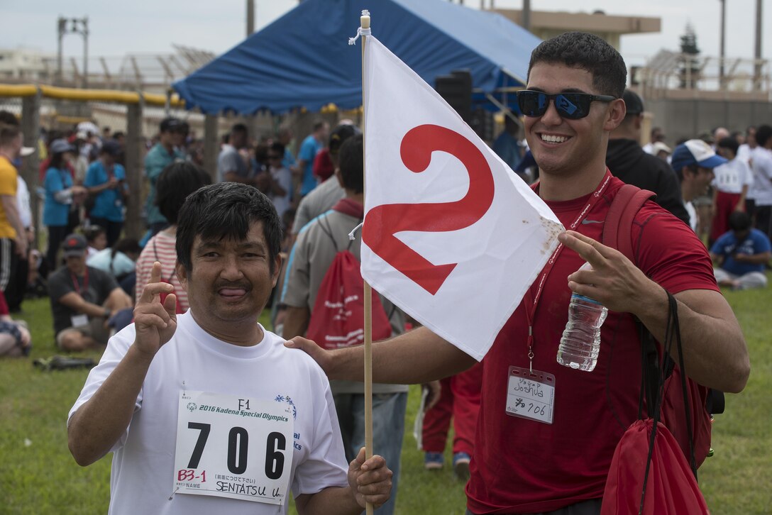 Sentatsu Unten, Kadena Special Olympics athlete, celebrates his second place finish in the softball throw with his athlete buddy Nov. 5, 2016, at Kadena Air Base, Japan. Thousands of spectators from Japan and the U.S. came out to support approximately 900 athletes and artists participating in the 16th annual KSO games and art show. (U.S. Air Force photo by Airman 1st Class Corey M. Pettis/Released)