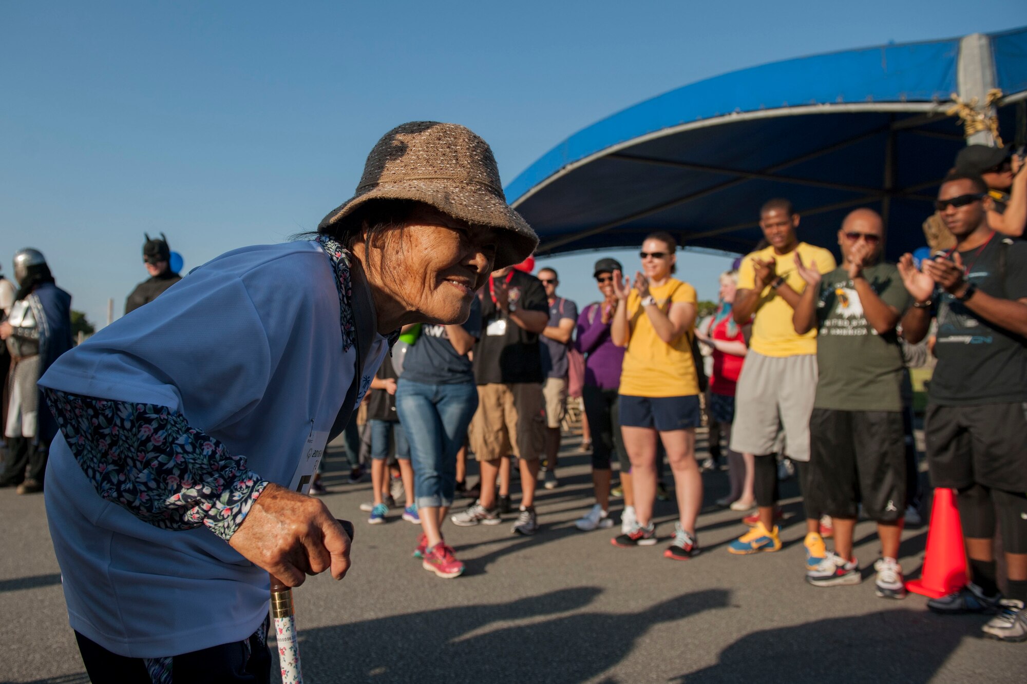Eiko, a Kadena Special Olympics athlete, receives greetings and cheers from event volunteers during the athlete arrival event Nov. 5, 2016, at Kadena Air Base, Japan.  Approximately 1,000 American volunteers paired up with more than 500 local interpreters to support KSO athletes who ranged from six to 95 years of age. (U.S. Air Force photo by Senior Airman Peter Reft/Released)