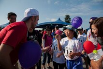 Hinata, a special-needs athlete, receives a balloon from KSO volunteers during the Kadena Special Olympics athlete arrival Nov. 5, 2016, at Kadena Air Base, Japan. KSO was established in 1999 by the 18th Wing commander Gen. John R. Baker as an avenue to build relations with the local communities and government representatives while providing a meaningful activity for the special needs children and adults. (U.S. Air Force photo by Senior Airman Peter Reft/Released)