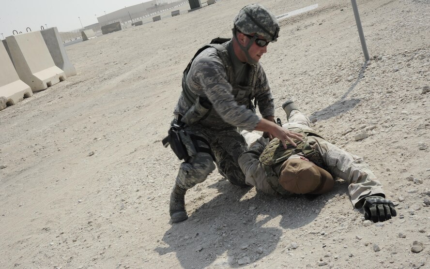 U.S. Air Force Airman 1st Class Matthew McDaniel, a patrolman with the 379th Expeditionary Security Forces Squadron, apprehends a simulated active shooter during an antiterrorism training exercise at Al Udeid Air Base, Qatar, Nov. 3, 2016. Training exercises like these incorporate real-world scenarios for Airmen to respond to in order to test, evaluate and improve upon the wing’s response measures. (U.S. Air Force photo by Senior Airman Cynthia A. Innocenti)