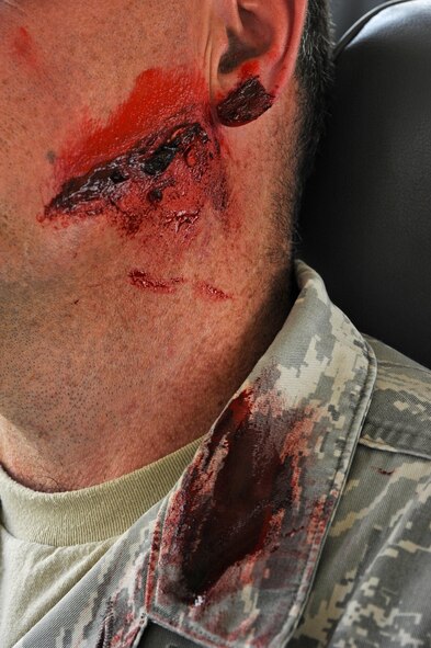 U.S. Air Force Master Sgt. David McWilliams, a first sergeant with the 379th Expeditionary Communications Squadron, portrays a victim in an active shooter event during an antiterrorism training exercise at Al Udeid Air Base, Qatar, Nov. 3, 2016. McWilliams wore moulage which is a technique of applying fake injuries used for the purpose of training emergency responders and medical personnel. (U.S. Air Force photo by Senior Airman Cynthia A. Innocenti)