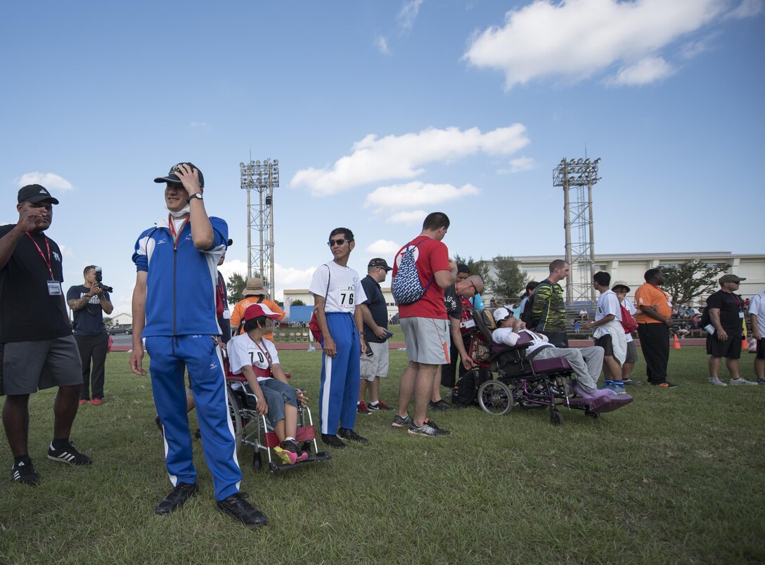 Kadena Special Olympians forma a circle-of-friendship during the closing ceremony of the Kadena Special Olympics Nov. 5, 2016, at Kadena Air Base, Japan. Athletes are paired together with a “buddy” during events. Buddies are U.S. service members who volunteered to help and encourage special-needs athletes as they compete and participate in different events. (U.S. Air Force photo by Senior Airman Omari Bernard/Released)