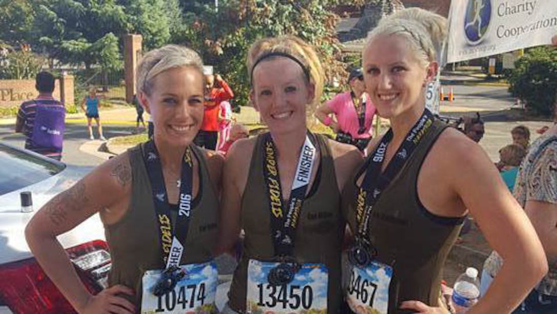 Marine veterans Jaclyn Halsey, Kasey Miller and Molly Zimmer pose for a photo after completing the 41st Marine Corps Marathon on Oct. 30, 2016 in Arlington, Va. The three girls went to boot camp together in 2009 and finished their service in 2012.  They have been training virtually together over the past year to prepare for the marathon, where they met for the first time since 2012.