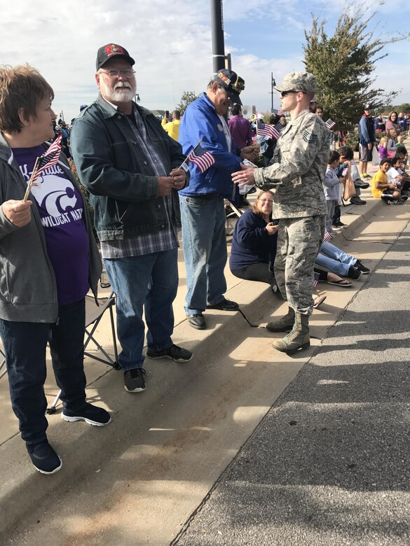 Tech. Sgt. Ray Wahl, 931st Air Refueling Wing Yellow Ribbon Coordinator, shakes hands with local community members at the 2016 Veterans Day Parade in downtown Wichita, Kansas, Nov. 5, 2016. The Total Force representation from the active duty 22nd Air Refueling Wing and the Reserve 931st Air Refueling Group took part in the parade as a way to honor U.S. military Veterans. (U.S. Air Force photo by Tech. Sgt. Abigail Klein)