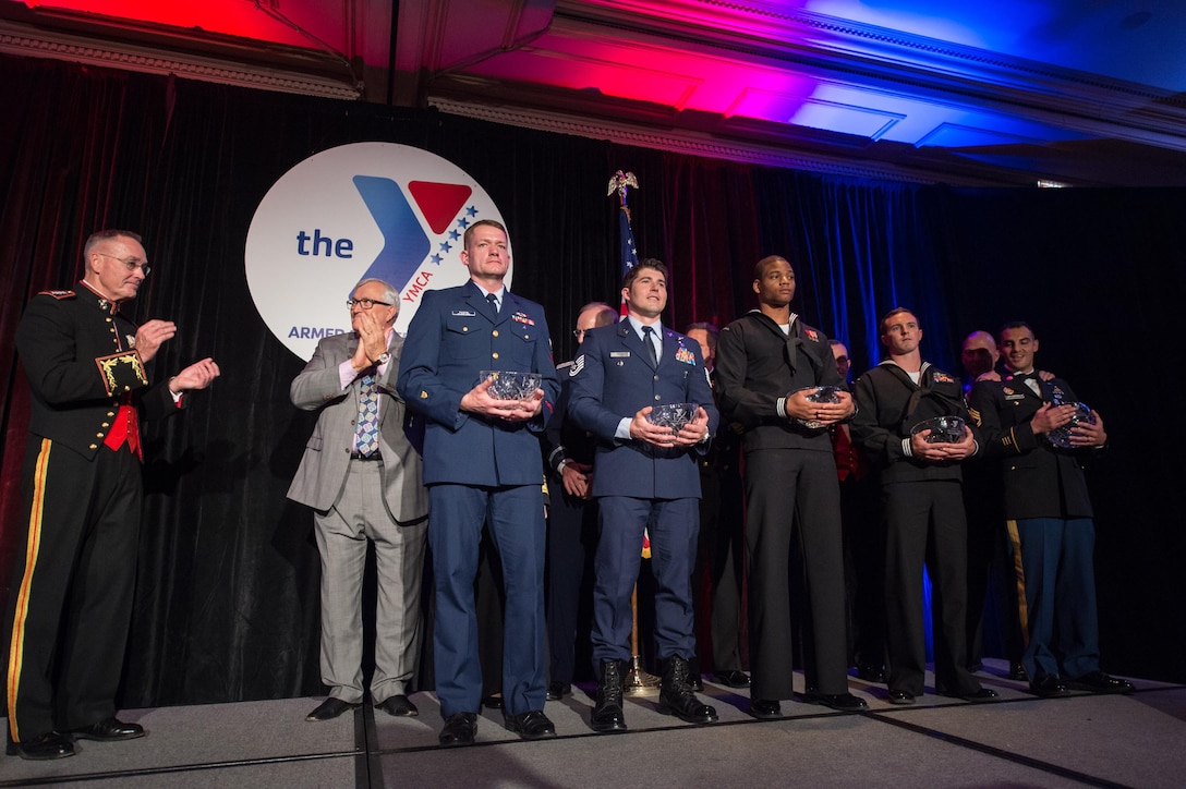 Marine Corps Gen. Joe Dunford, chairman of the Joint Chiefs of Staff, far left, congratulates the 2016 Armed Services YMCA “Angels of the Battlefield” award recipients during a gala in Arlington, Virginia, Nov. 4, 2016. The recipients are: Coast Guard Petty Officer 2nd Class Ryan Ransom, Air Force Tech. Sgt. Cody C. Inman, Navy Seaman Elgie O. McCoy Jr., Petty Officer 2nd Class Nicholas Otazo, and Army Sgt. 1st Class Daniel Lopez-Bonaglia. The 10th annual Angels of the Battlefield Awards Gala honored medics, corpsmen and pararescuemen who demonstrated extraordinary courage while administering life-saving medical treatment and trauma care on the battlefield. DoD Photo by Army Sgt. James K. McCann