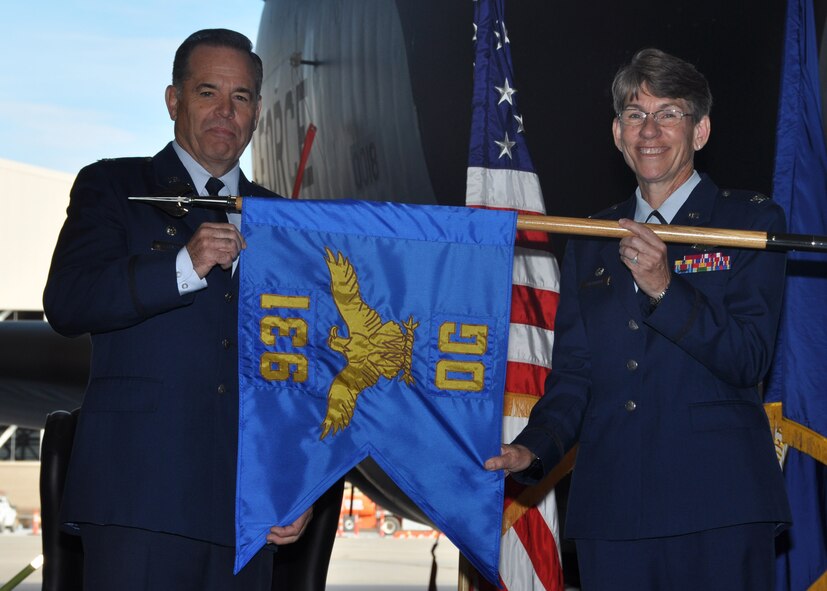 Col. Mark S. Larson, left,  931st Air Refueling Wing commander, and Col. Caroline B. Evernham, incoming 931st Operations Group commander, unfurl the 931 OG guidon during an assumption of command ceremony Nov. 5, 2016, McConnell Air Force Base, Kan. The unfurling of the guidon represents the establishment of the 931 OG as an official unit within the 931 ARW. (U.S. Air Force photo by Senior Airman Preston Webb)