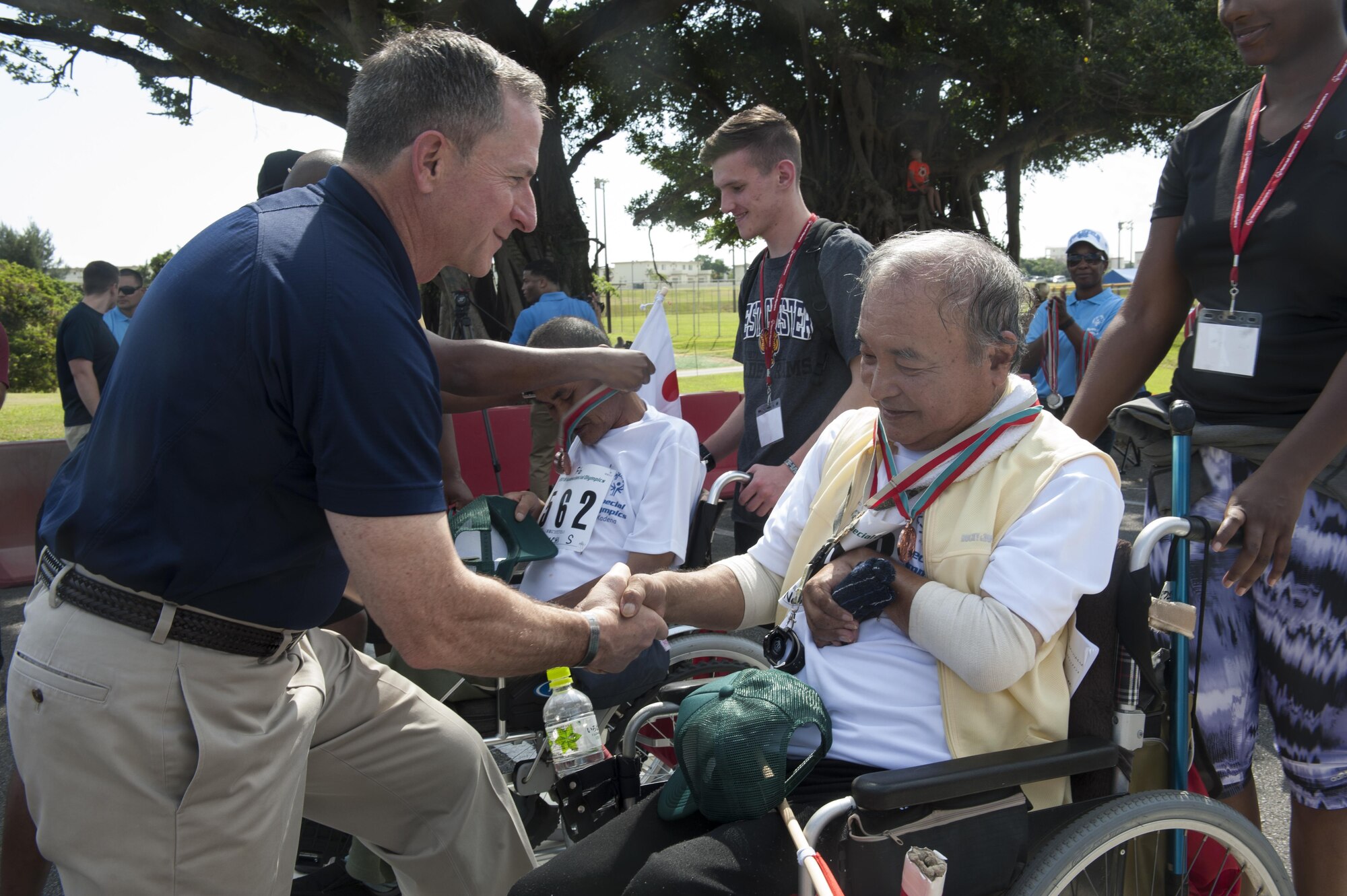 Air Force Chief of Staff Gen. Dave Goldfein congratulates a Kadena Special Olympics athlete Nov. 5, 2016, at Kadena Air Base, Japan. The KSO is a one-day sporting, art and entertainment event with more than 880 athletes and artists participating in a day of competition, music and special recognition. (U.S. Air Force photo by Senior Airman Lynette M. Rolen/Released)