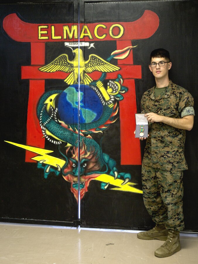 U.S. Marine Cpl. Riki D. Clement, a micro/miniature repair man with Electronics Maintenance Company, 3rd Maintenance Battalion, III Marine Expeditionary Force, displays his Navy and Marine Corps Achievement medal he received for exceptional innovation at Camp Kinser, Okinawa, Japan, Oct. 20, 2016. Clement repaired a radio tester unit using a Vehicular Amplifier Unit, saving the Marine Corps nearly $64,000 in logistics and maintenance. (U.S. Marine Corps photo by Lance Cpl. Breanna Weisenberger)
