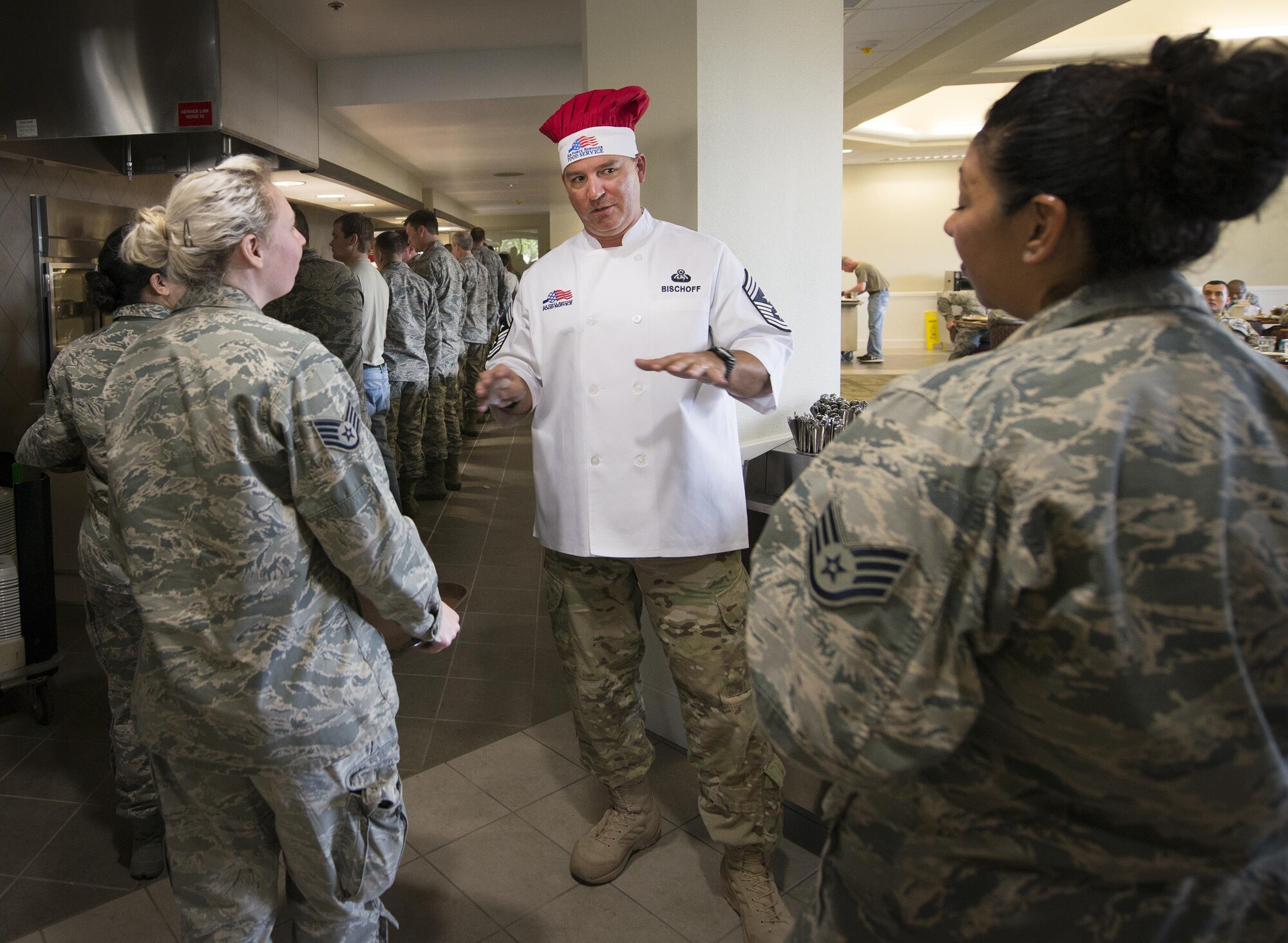 Chief Master Sgt. Brian Bischoff, the 919th Special Operations Wing command chief, talks with Airmen at the newly reopened dining facility at Duke Field, Nov. 5.  The chief was there with other wing leadership to serve the holiday meal.  The dining facility was shut down for more than a year while undergoing renovations.  (U.S. Air Force photo/Tech. Sgt. Jasmin Taylor)