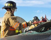 A 919th Special Operations Wing firefighter clears glass from the back window during a car extraction training exercise at Duke Field, Fla., Nov. 6. The wing’s firefighters took part in the exercise to meet their bi-annual training requirement.  (U.S. Air Force photo/Dan Neely)