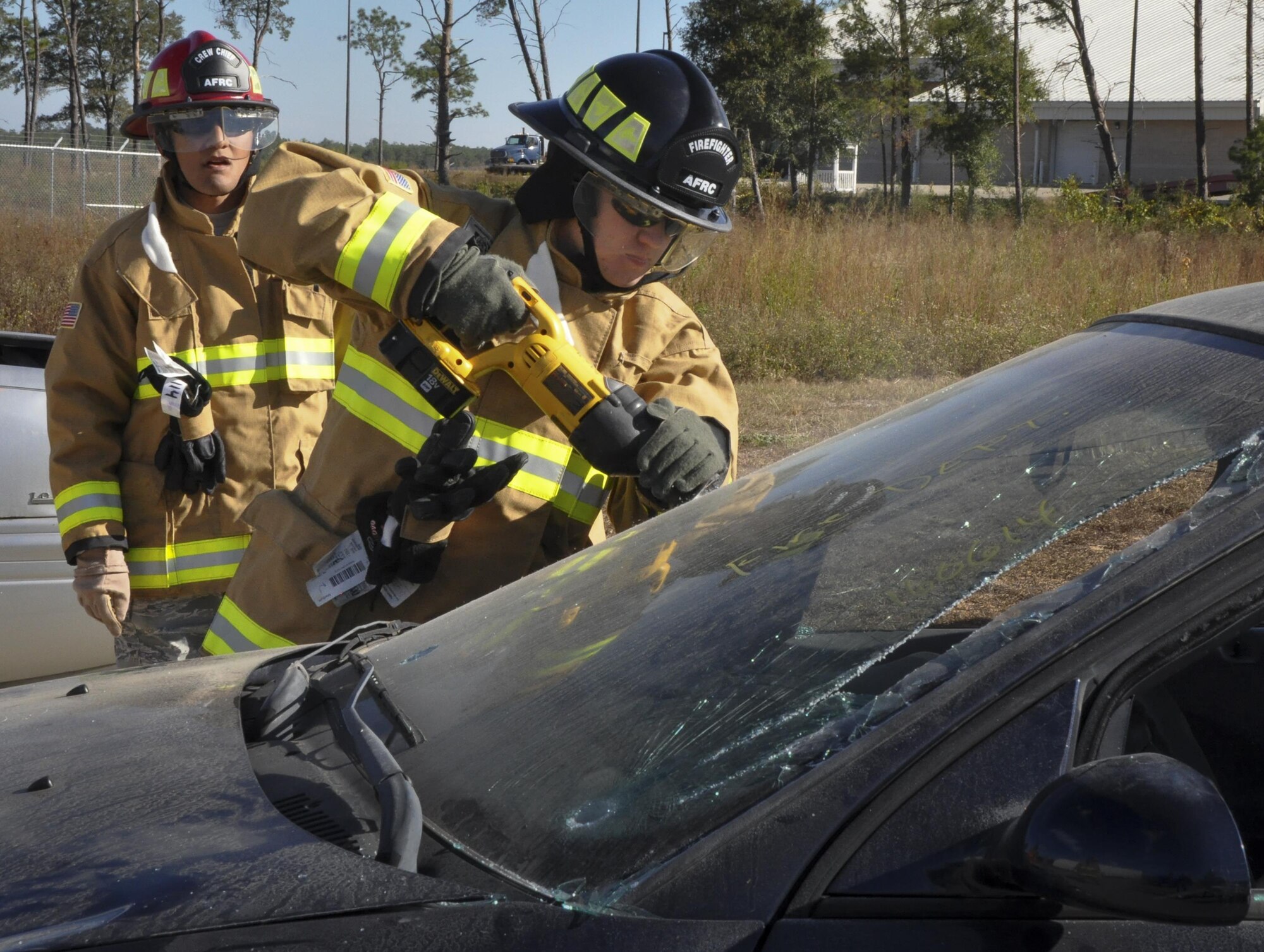 A 919th Special Operations Wing firefighter uses a saw to cut through a windshield during a car extraction training exercise at Duke Field, Fla., Nov. 6. The wing’s firefighters took part in the exercise to meet their bi-annual training requirement.  (U.S. Air Force photo/Dan Neely)