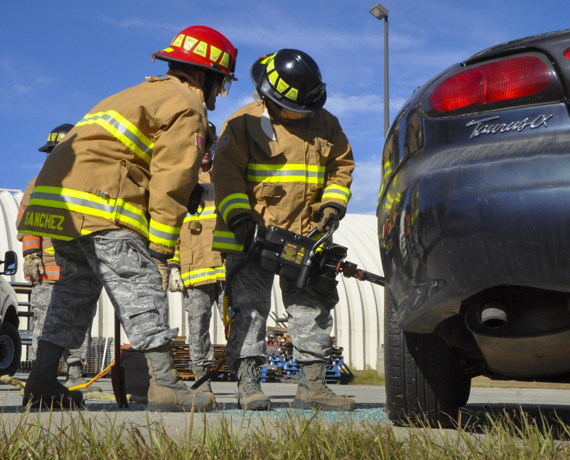 A 919th Special Operations Wing firefighter uses a prying tool to open the car door during an extraction training exercise at Duke Field, Fla., Nov. 6. The wing’s firefighters took part in the exercise to meet their bi-annual training requirement.  (U.S. Air Force photo/Dan Neely)