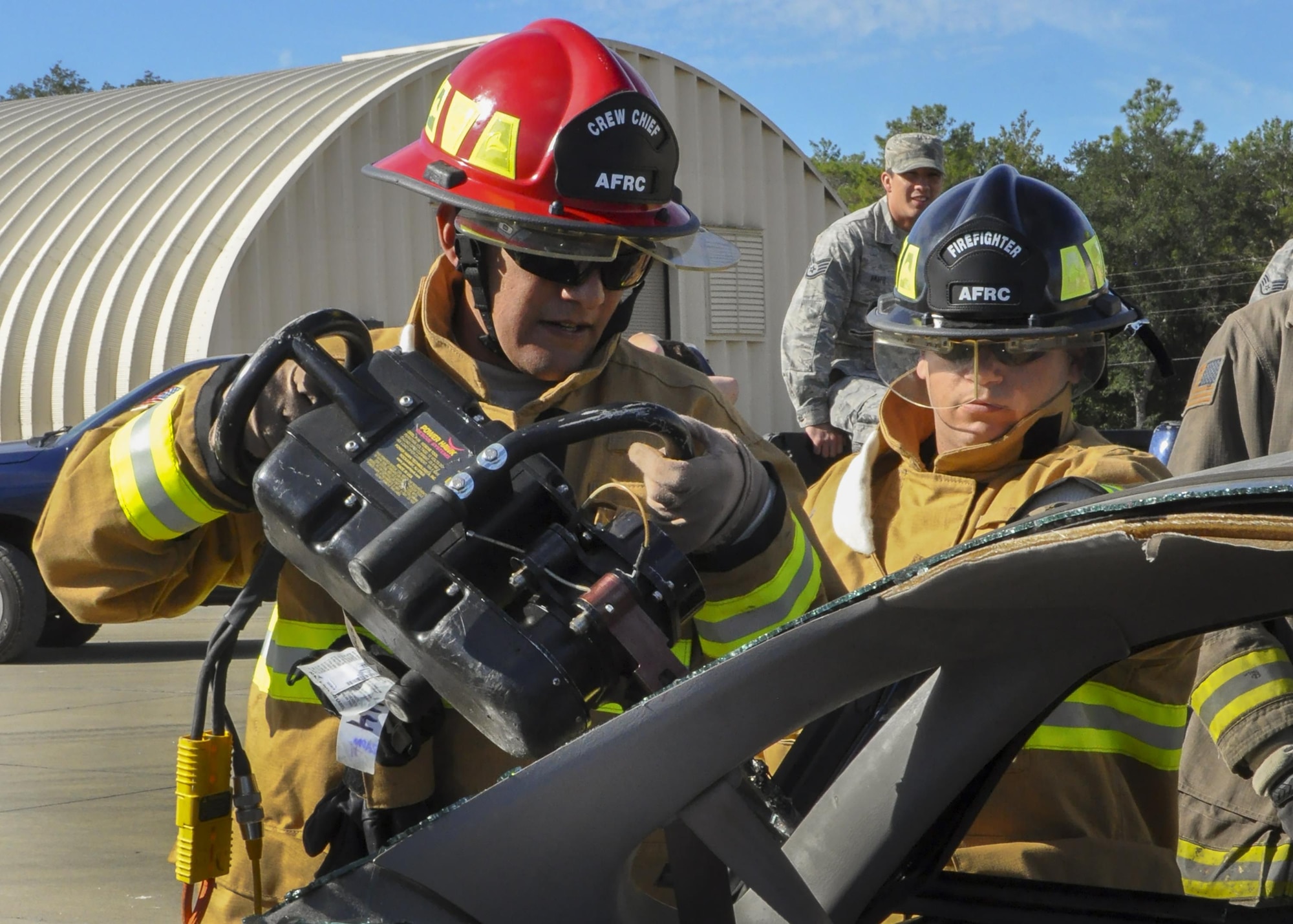A 919th Special Operations Wing firefighter uses a prying tool to open the car door during an extraction training exercise at Duke Field, Fla., Nov. 6. The wing’s firefighters took part in the exercise to meet their bi-annual training requirement.  (U.S. Air Force photo/Dan Neely)