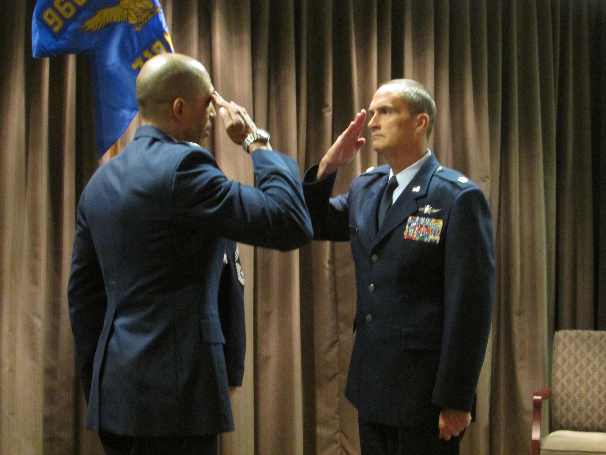 Col. Anthony M. Perkins, 960th Cyberspace Operations Group commander, and Maj. Karl Miller, 710th Network Operations Squadron commander, exchange salutes during an activation ceremony at Robins Air Force Base, Ga., Nov. 6. Miller assumed command of the unit, as its first commander. (U.S. Air Force photo by 2nd. Lt. Michael Wisniewski)