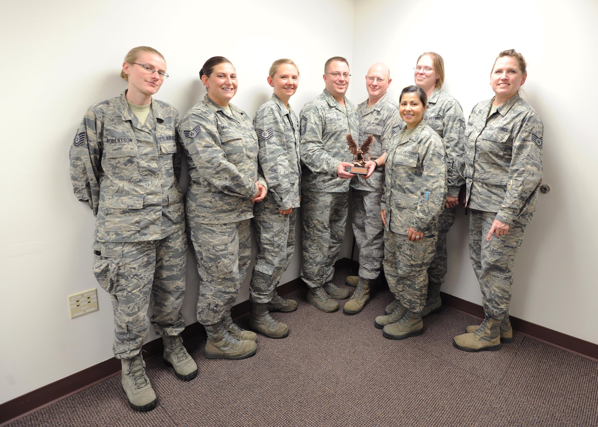 The 446th Force Support Squadron’s Education and Training Flight holds up their 2015 Nathan Altschuler Outstanding Education and Training Program of the Year trophy November 6, 2016,  at Joint Base Lewis-McChord, Wash. In addition to winning the award for best education and training office in the entire reserve command, Senior Master Sgt. John Besselman, 446th FSS chief of force development, was named the Force Support Noncommissioned Officer of the Year for AFRC. (U.S. Air Force Reserve photo by Tech. Sgt. Bryan Hull)