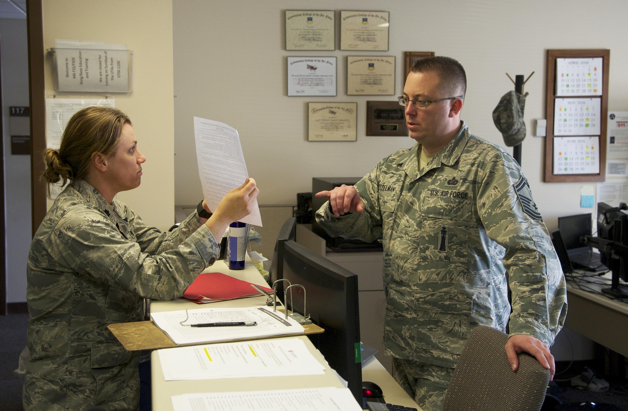 Senior Master Sgt. John Besselman, 446th Force Support Squadron chief of force development, discusses education benefits with Lt. Col. Jennifer Hrivnak, 446th Aeromedical Squadron, May 1, 2016 in the education and training office. The 446th FSS Education and Training Office was awarded the Nathan Altschuler Outstanding Education and Training Program of the Year April 16, 2016 by Air Force Reserve Command. Besselman was named the Force Support Noncommissioned Officer of the Year for AFRC. (U.S. Air Force photo by Tech. Sgt. Bryan Hull)