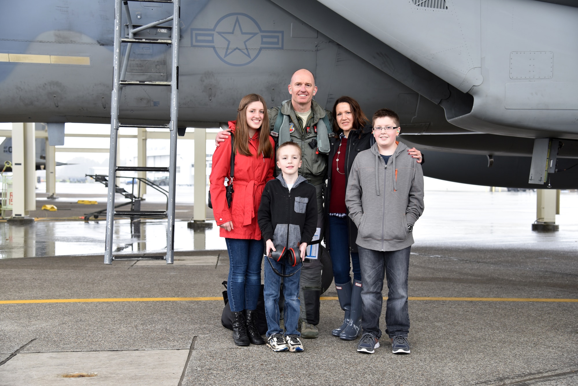 Oregon Air National Guard Col. Paul T. Fitzgerald, 142nd Fighter Wing Commander pauses for a photograph with his family after his Fini Flight in the F-15 Eagle, Nov. 5, 2016, Portland Air National Guard Base, Ore. (U.S. Air National Guard photo by Senior Master Sgt. Shelly Davison, 142nd Fighter Wing Public Affairs) 