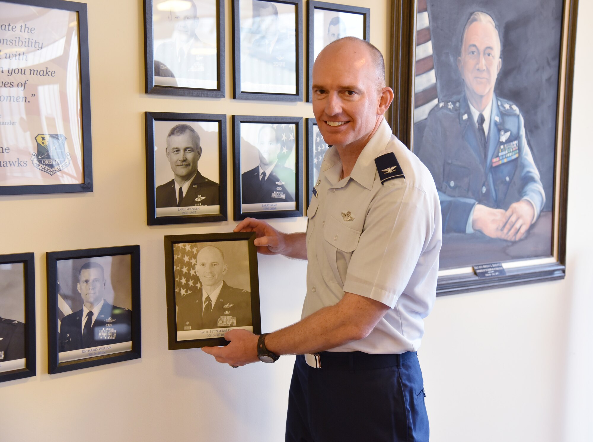 U.S. Air Force Col. Paul T. Fitzgerald, 142nd Fighter Wing commander hangs his photograph on the wall of retired wing commanders prior to his official retirement, Nov. 6, 2016, Portland Air National Guard Base, Ore. (U.S. Air National Guard photo by Senior Master Sgt. John Hughel, 142nd Fighter Wing Public Affairs). 