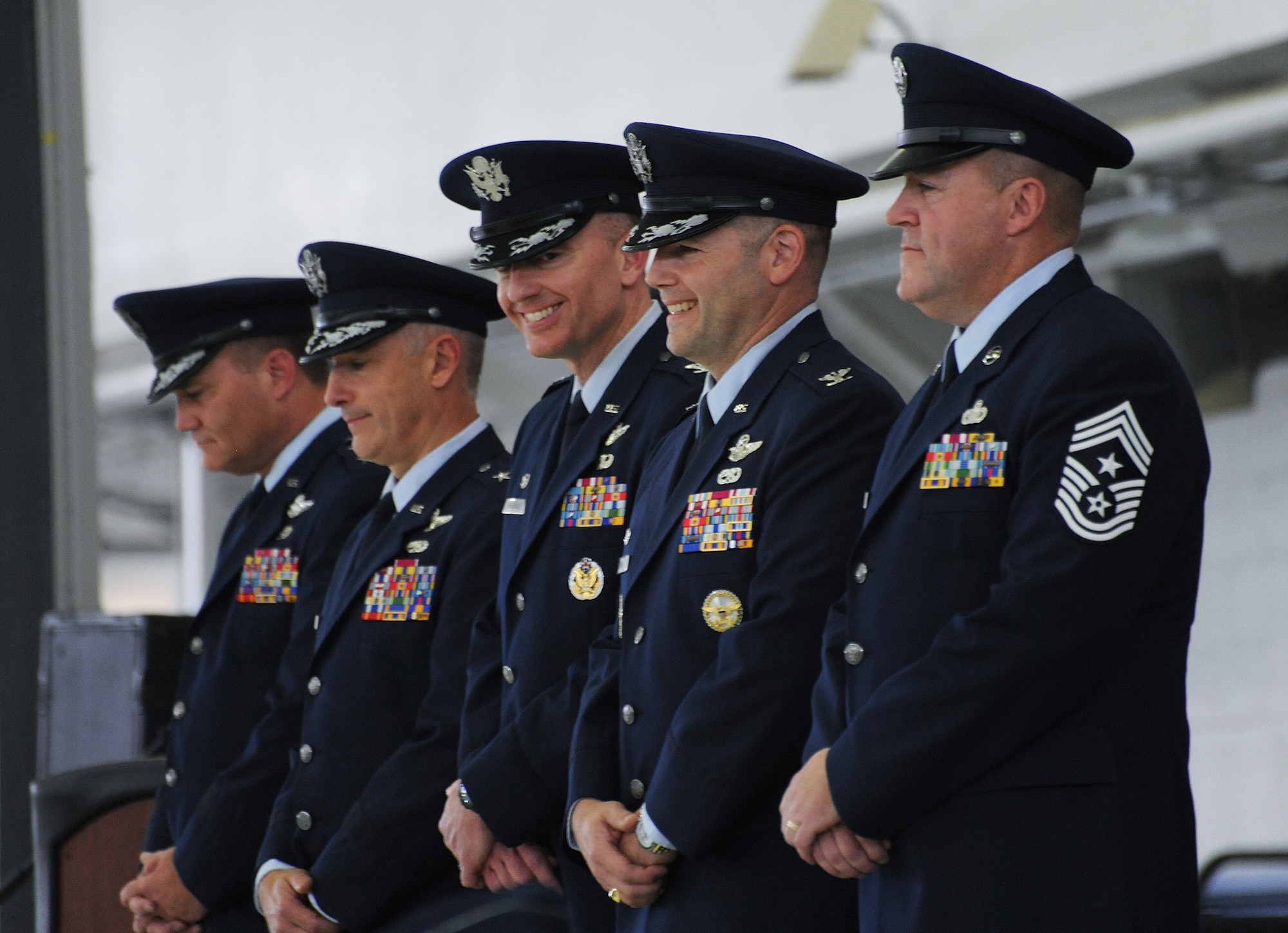 Members of the Oregon Air National Guard Change of Command Party enjoy a lighter moment during the ceremony as Col. Paul T. Fitzgerald, (center) hands the command to Col. Duke A. Pirak, (fourth from left), Portland Air National Guard Base, Ore., Nov. 6, 2016. (U.S. Air National Guard photo by Tech. Sgt. John Hughel, 142nd Fighter Wing Public Affairs).