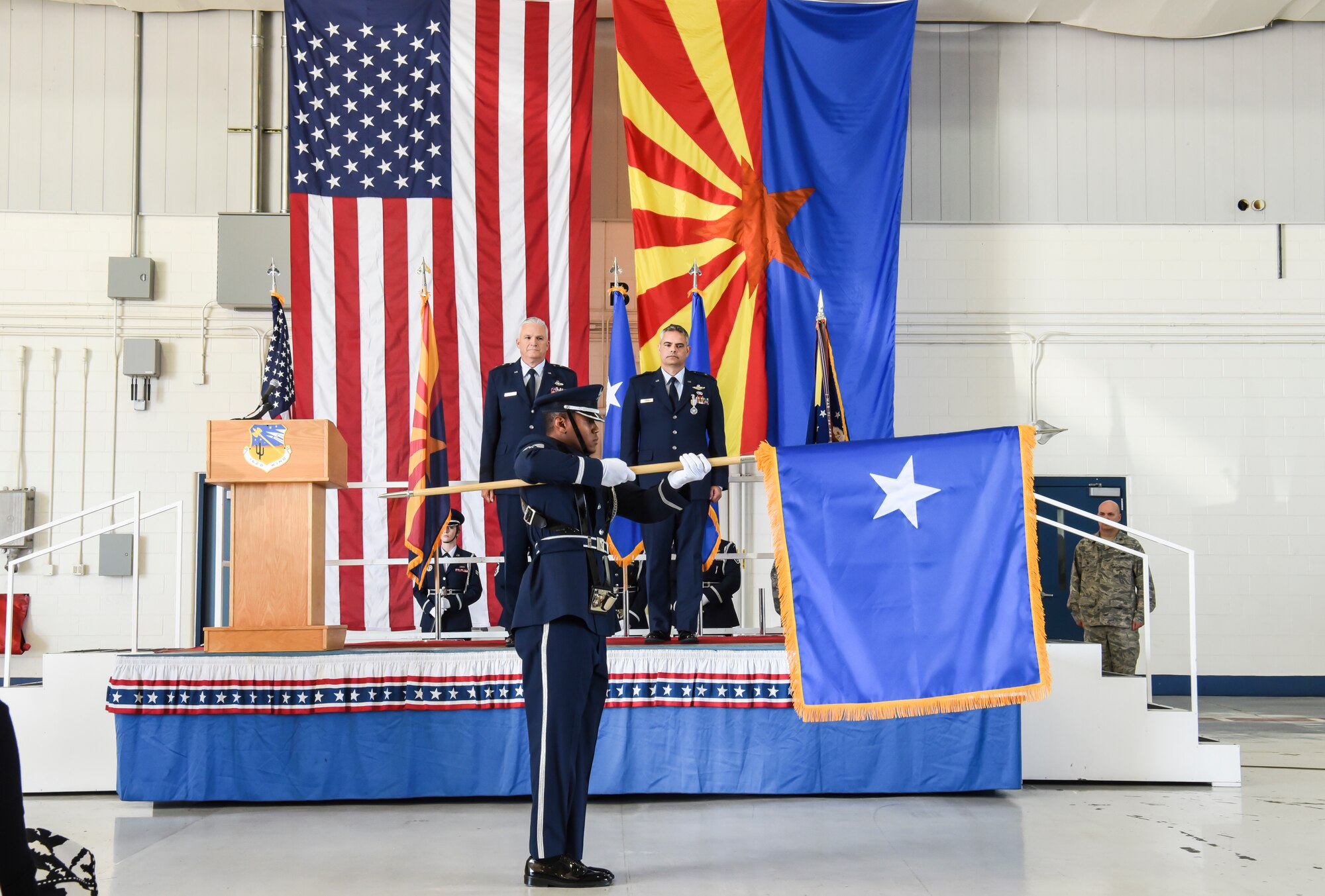 U.S. Air Force Staff Sgt. Eddie Jones, a member of the 162nd Wing honor guard, unfurls the brigadier general flag at a change of command ceremony at the 162nd Wing in Tucson, Ariz., Nov. 5, 2016.  The Air Force incorporates the use of flags to signify the presence of a general officer.  (U.S. Air National Guard photo by Tech. Sgt. Hollie A. Hansen)