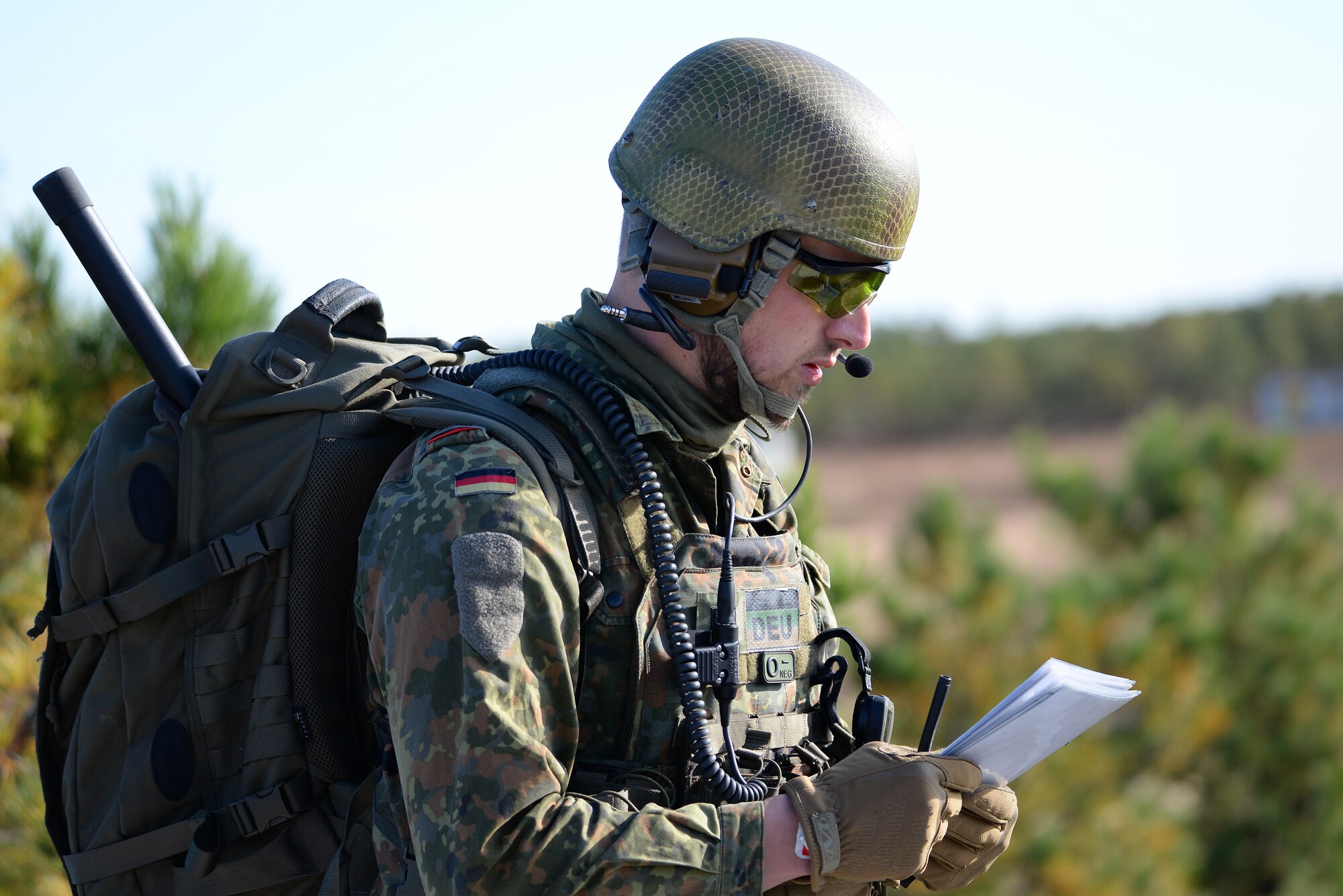 A picture of German armed forces Joint Terminal Attack Controller (JTAC) Capt. Tim Jantzen listening to a read back of nine line information.