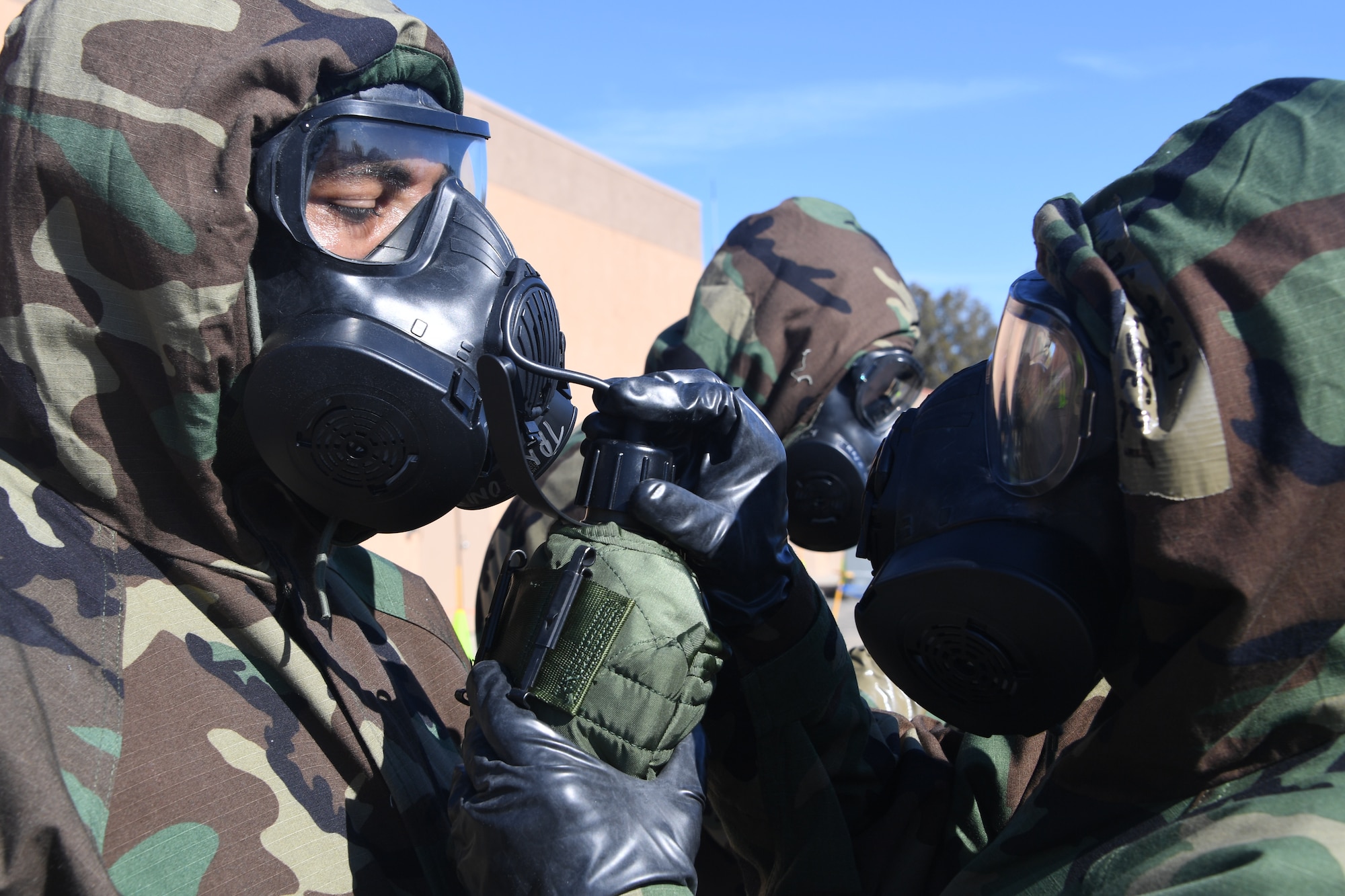 U.S. Air National Guardsmen at the 146th Airlift Wing participate in an Expeditionary Skills Rodeo on November 4, 2016. During the exercise participants practiced how to use the canteen will donning the gas mask. (U.S. Air National Guard photo by Senior Airman Madeleine Richards/Released)