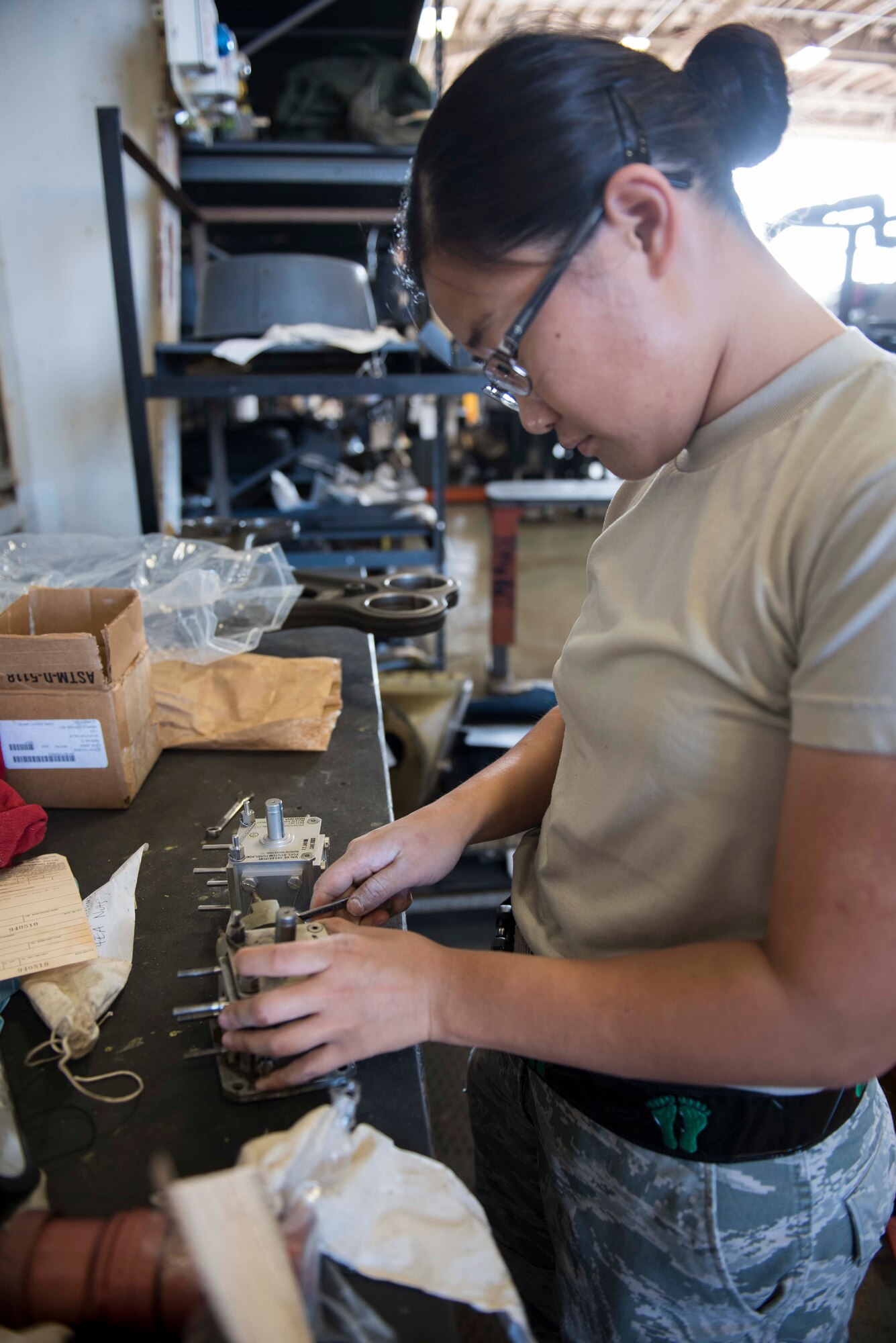U.S. Air Force Airman 1st Class Chanell Um, 33rd Helicopter Maintenance Unit propulsion specialist, replaces the gasket to a fuel selector valve of an HH-60G Pavehawk during a phase inspection, Nov. 3, 2016, at Kadena Air Base, Japan. Pavehawks receive phase inspections every 600 flight hours to maintain and extend the life cycle of the aircraft. (U.S. Air Force photo by Senior Airman Omari Bernard/Released)