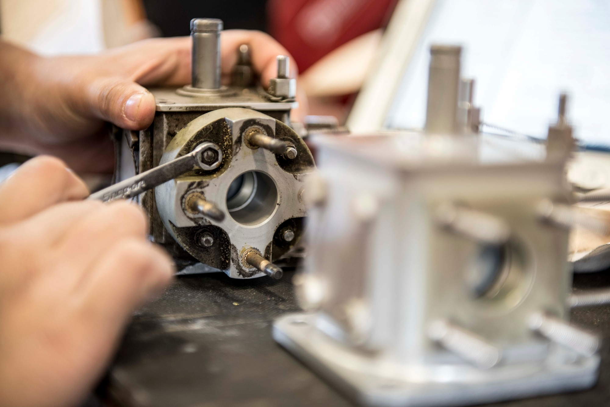 U.S. Air Force Airman 1st Class Chanell Um, 33rd Helicopter Maintenance Unit propulsion specialist, replaces the gasket to a fuel selector valve of an HH-60G Pavehawk during a phase inspection, Nov. 3, 2016, at Kadena Air Base, Japan. During phase inspection the 33rd HMU’s phase technicians take apart the Pavehawk while looking for damage, worn or corroded parts. (U.S. Air Force photo by Senior Airman Omari Bernard/Released)