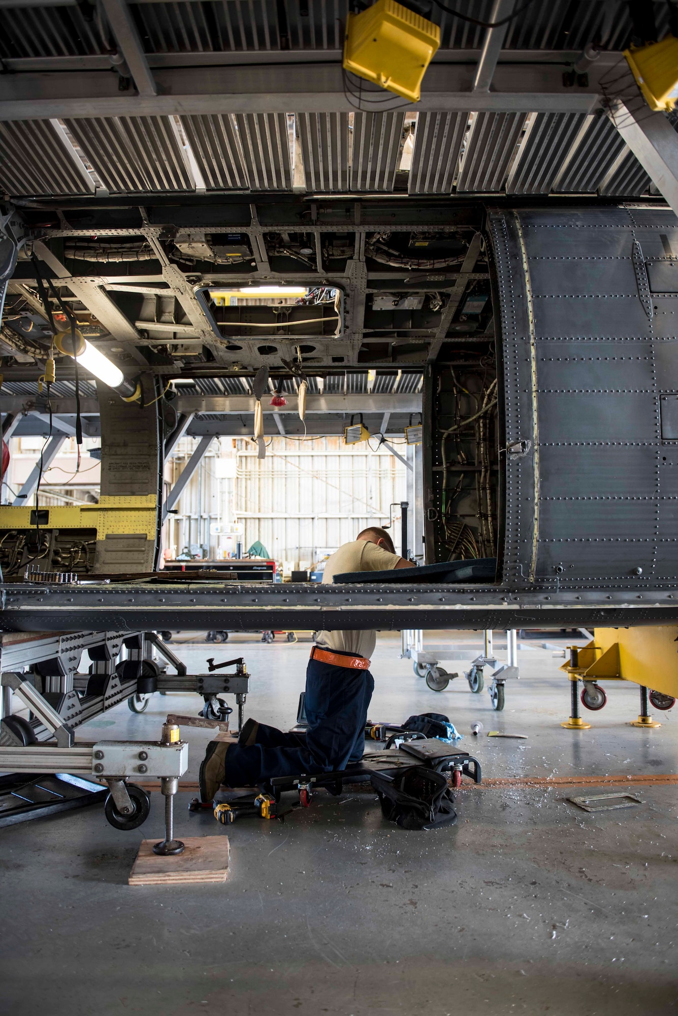 U.S. Air Force Staff Sgt. Joseph Ogorek, 33rd Helicopter Maintenance Unit HH-60G Pavehawk crew chief, inspects the belly of a Pavehawk during a phase inspection Nov. 3, 2016, at Kadena Air Base, Japan. A phase inspection can last 45 days or longer, while technicians inspect every part of the aircraft. (U.S. Air Force photo by Senior Airman Omari Bernard/Released)