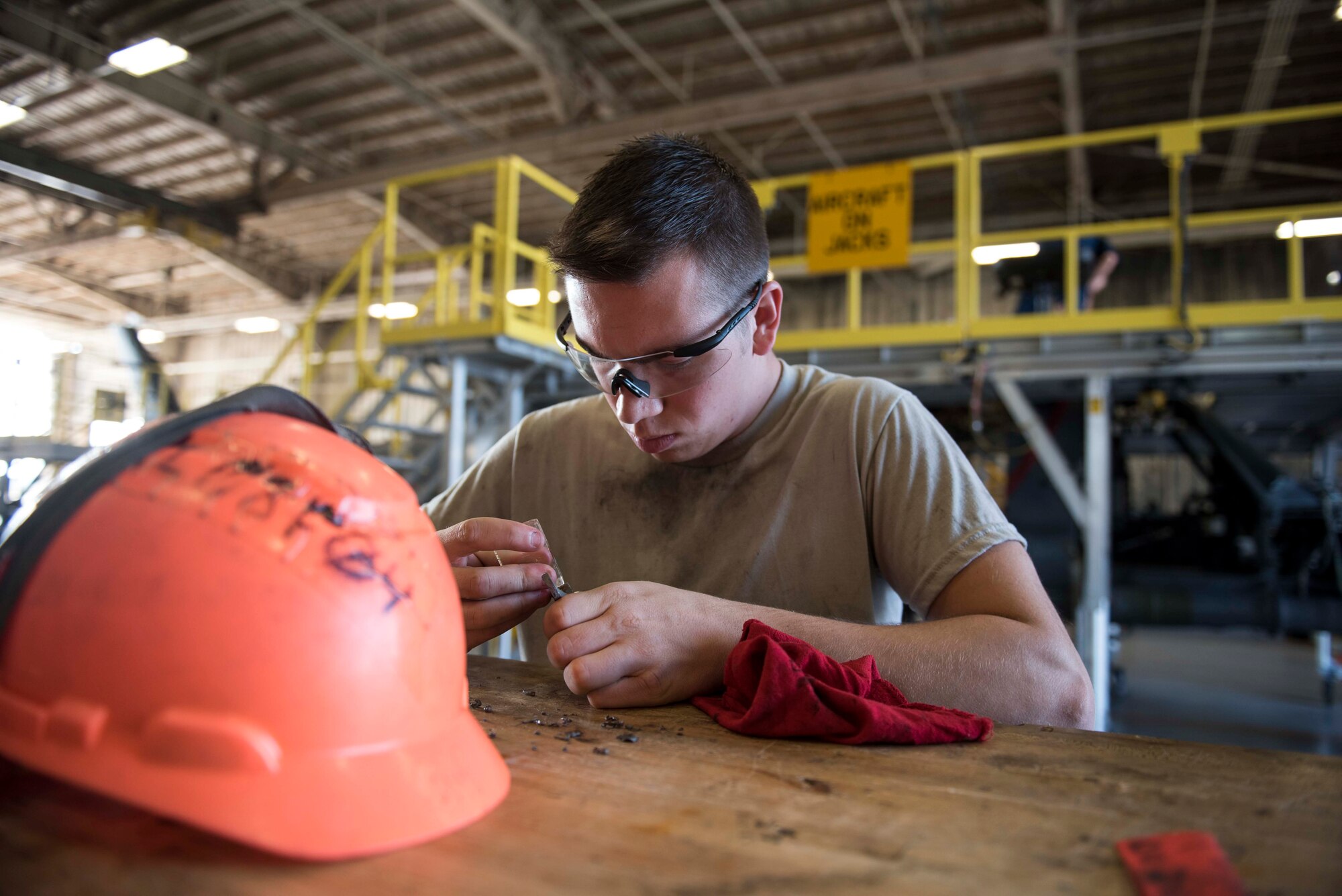 U.S. Air Force Senior Airman Skyler Bollschweiler, 33rd Helicopter Maintenance Unit HH-60G Pavehawk crew chief, cleans the sealant of a Pavehawk bearing support during a phase inspection Nov. 3, 2016, at Kadena Air Base, Japan. The phase inspection team inspect a total of 1,136 items for the Pavehawk. (U.S. Air Force photo by Senior Airman Omari Bernard/Released) 