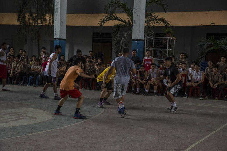 U.S. Marines and Sailors with Marine All-Weather Fighter Attack Squadron (VMFA (AW)) 225 play a game of basketball against Sekolah Menengah Atas Negeri 1 High School students in Manado, Indonesia, Nov. 4, 2016. As part of a community relations event, the visit offered service members the opportunity to engage in cultural exchanges and build relationships within the local community. Upon arrival to the school, the Marines and Sailors were greeted by the students with cheering and excitement. The Marines and Sailors then played basketball against the students, losing 32-26 after completing two games. Service members then intermixed with the students and played one more game before finishing the event. (U.S. Marine Corps photo by Cpl. Aaron Henson)