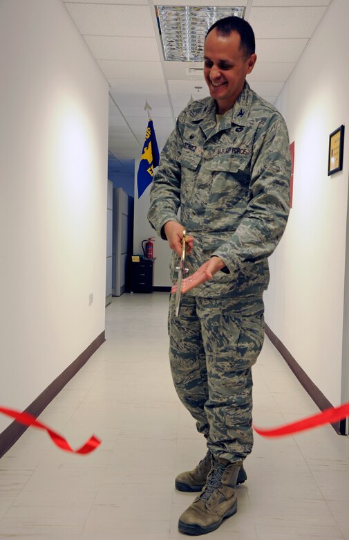 U.S.Air Force Col. Timothy Martinez, the 379th Expeditionary Medical Group commander,cuts a ribbon to signify the opening of the new 379th Medical Group Administration Building at AIUdeid Air Base, Qatar,Nov. 2,2016.The new facility allows for an expansion of available services in one consolidated location. (U.S.Air Force photo by Senior Airman Cynthia A.Innocenti)