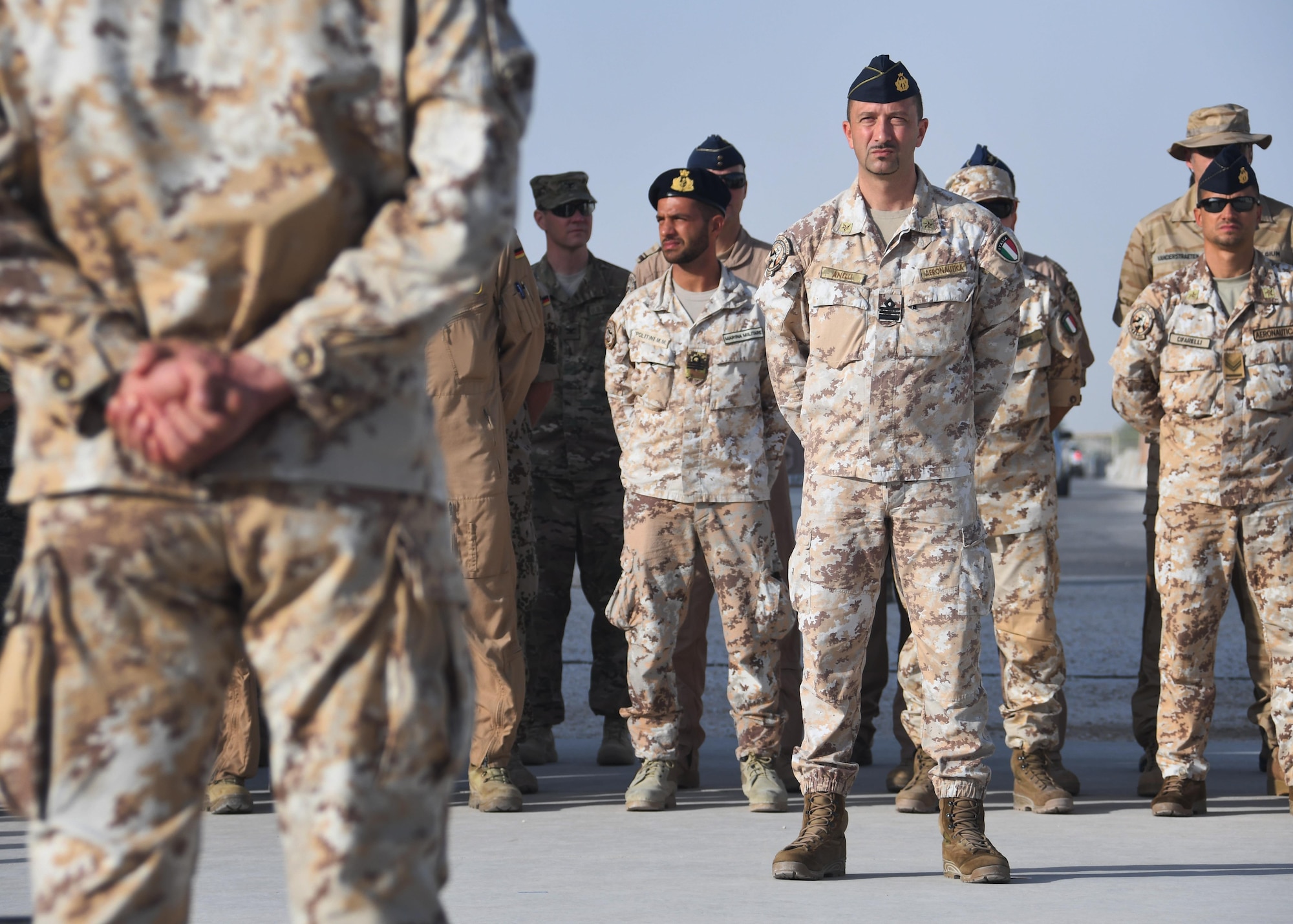 Members from the Italian Detachment at the Combined Air Operations Center stand in formation during the Italian Armed Forces Day ceremony at Al Udeid Air Base, Qatar Nov. 4, 2016. The ceremony was held in front of the Memorial Plaza and involved the raising of the Italian flag, a moment of silence and the presentation of certificates of appreciation. (U.S. Air Force photo by Senior Airman Miles Wilson)