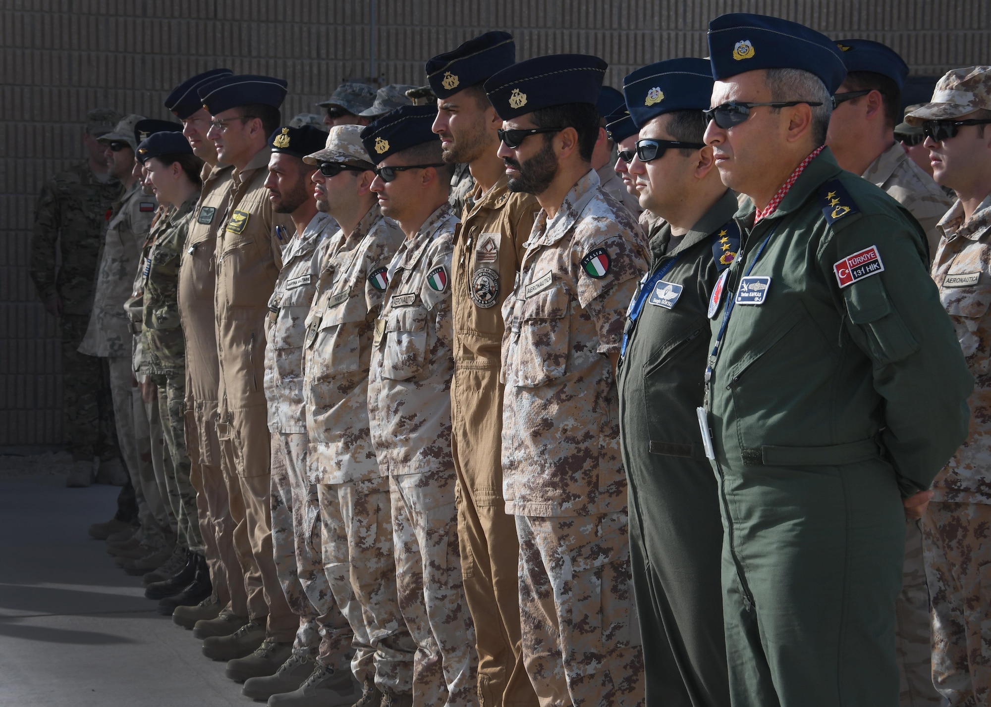 Members of the Italian Detachment at the Combined Air Operations Center stand in formation at Al Udeid Air Base, Qatar, Nov. 4, 2016. The Italian detachment, as well as distinguished guests from all over Al Udeid Air Base, gathered at the Memorial Plaza in recognition of Italian Armed Forces Day. (U.S. Air Force Photo by Senior Airman Miles Wilson)