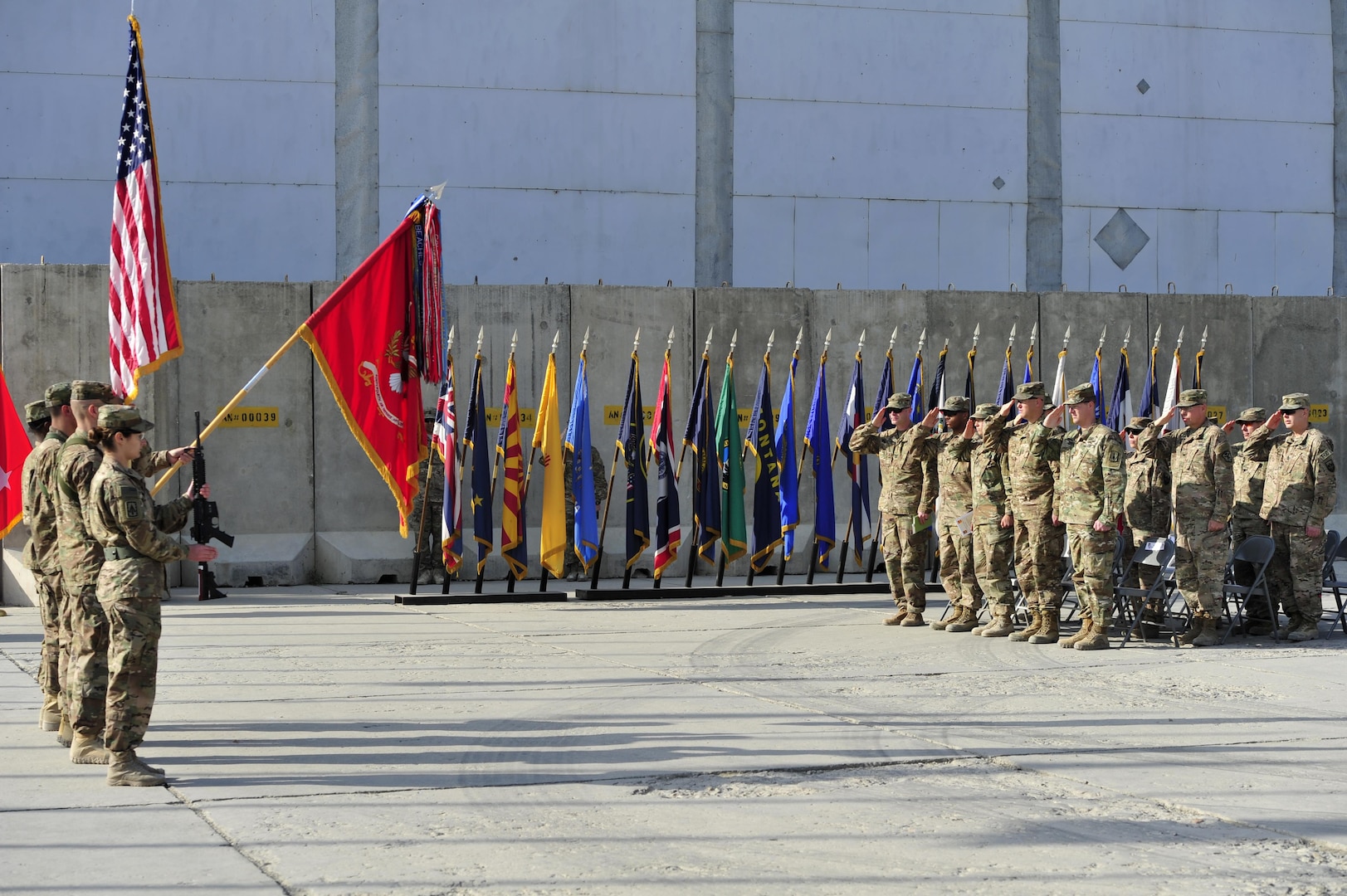 BAGRAM AIRFIELD, AFGHANISTAN (Nov. 2, 2016) - The color guard, dignitaries, and guests render honors to the flag during the national anthem at the transfer of authority ceremony from 2nd Battalion, 44th Air Defense Artillery Regiment to the 5th Battalion, 5th Air Defense Artillery Regiment.  The ADA battalion provides counter rocket, artillery, and mortar protection to Bagram Airfield.  Photo by Bob Harrison, U.S. Forces Afghanistan Public Affairs.