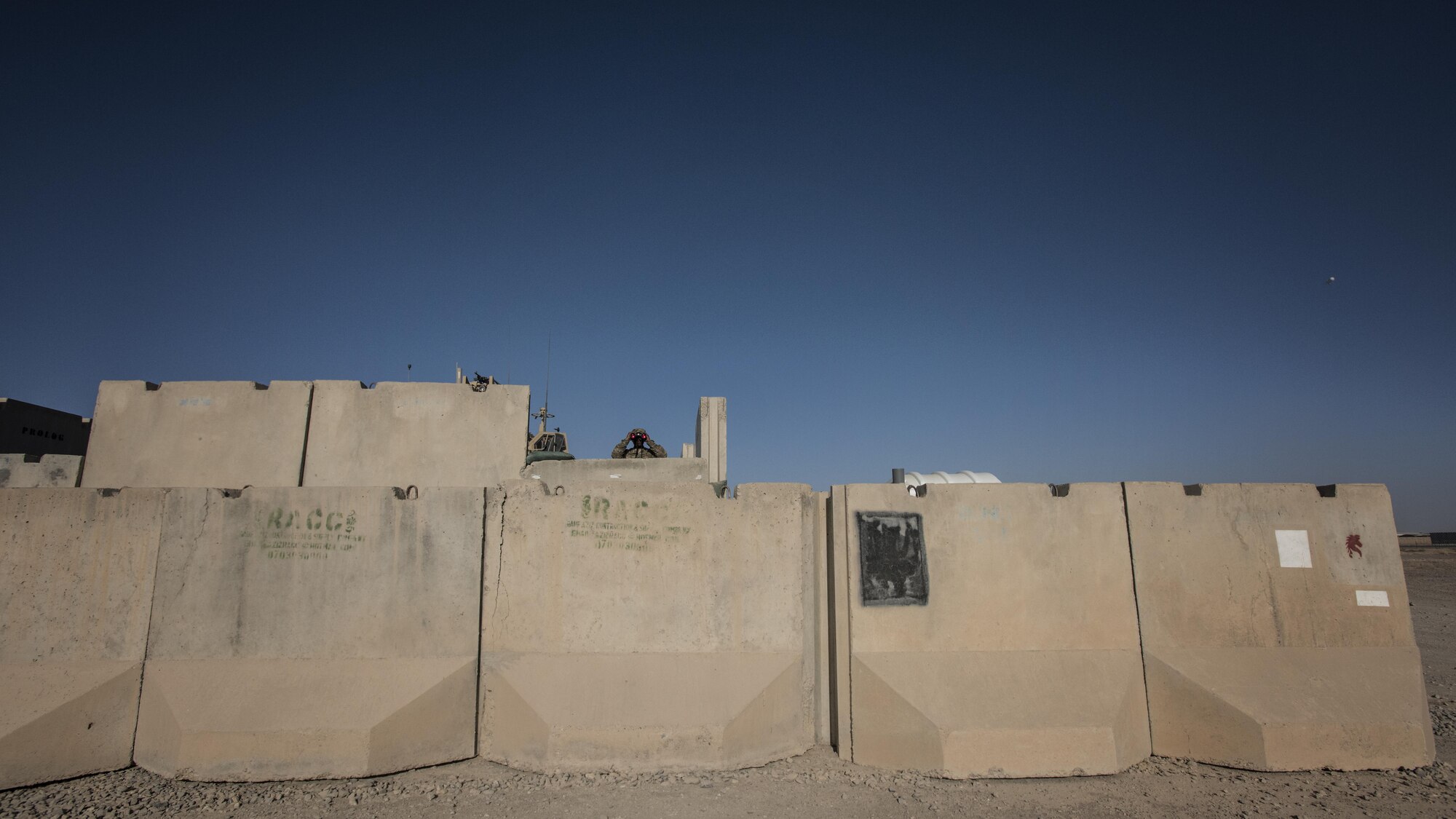 Senior Airman James Curry, 451st Expeditionary Support Squadron response force member, uses binoculars to monitor his team’s security sector at Kandahar Airfield, Afghanistan Nov. 5, 2016. Response force teams are posted around the airfield at Kandahar to ensure 365-degree security. (U.S. Air Force photo by Staff Sgt. Katherine Spessa)

