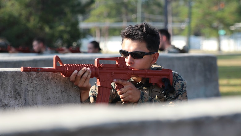 A Marine with the 24th Marine Expeditionary Unit's law enforcement detachment provides security while an assault element makes its approach during an urban patrol. The military policemen served as a notional partner nation force for a team of Marine Raiders from Marine Corps Forces, Special Operations Command during the MEU's Realistic Urban Training Exercise, Nov. 2, 2016.