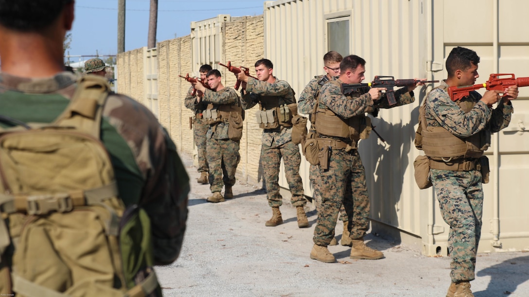 A Marine Raider from Marine Corps Forces, Special Operations Command, watches attentively as he mentors military policemen from the 24th Marine Expeditionary Unit's law enforcement detachment Nov. 2, 2016. The two groups of Marines were training to develop the urban patrolling and combat skills of the law enforcement detachment as part of their Realistic Urban Training exercise. The group served as a notional partner nation force for the Raiders to refine their coaching and mentoring skills on.