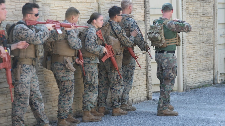 A Marine Raider from Marine Corps Forces, Special Operations Command, instructs military policemen from the 24th Marine Expeditionary Unit's law enforcement detachment during partnered urban training, Nov. 2, 2016. The two groups of Marines were training to develop the urban patrolling and combat skills of the law enforcement detachment as part of their Realistic Urban Training exercise. The group served as a notional partner nation force for the Raiders to refine their coaching and mentoring skills on.