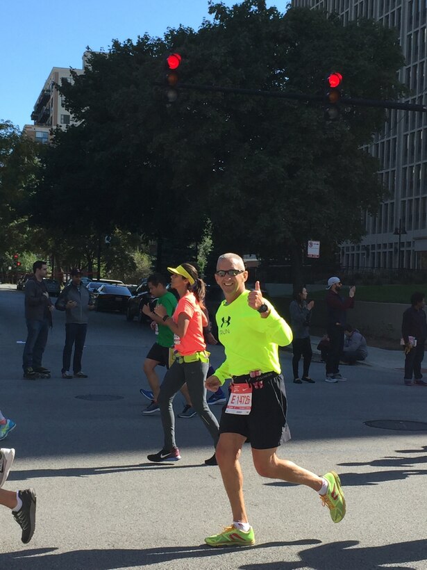 Senior Master Sgt. Todd Kirkwood, 167th avionics superintendent, gives a thumbs up at mile 25 of the Chicago Marathon, Oct. 9, 2016. Kirkwood ran the marathon only eight months after undergoing chemotherapy and radiation treatments for cancer.