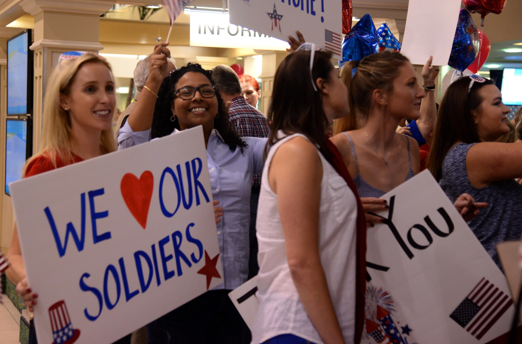 A group of community members hold signs to honor veterans at St. Pete-Clearwater International Airport Nov. 1, 2016. Community members made signs, brought flags and cheered for war veterans as they arrived home from their trip to Washington D.C. 