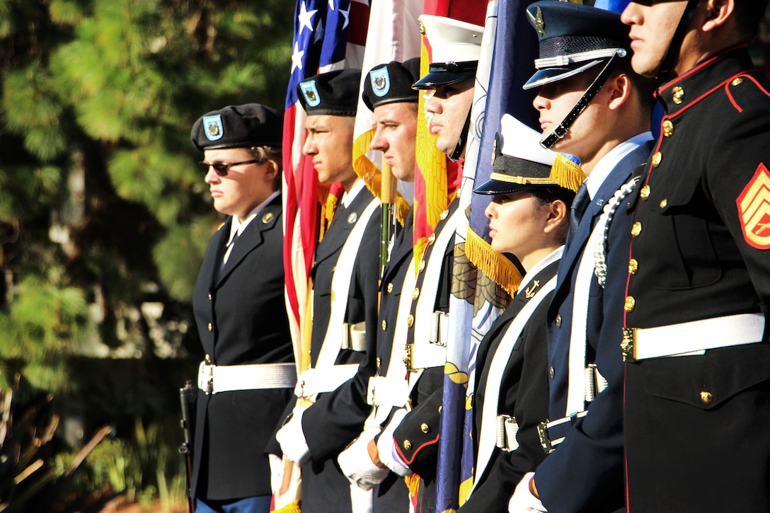 The San Diego State University ROTC Color Guard awaits the start of a wreath-laying ceremony at the War Memorial on Aztec Green at San Diego State University, San Diego, Nov. 4, 2016. The memorial honors 239 former San Diego State students lost in service to their country during World War II, the Korean and Vietnam Wars as well as in Iraq and Afghanistan. Navy photo by Lt. Matthew Stroup
