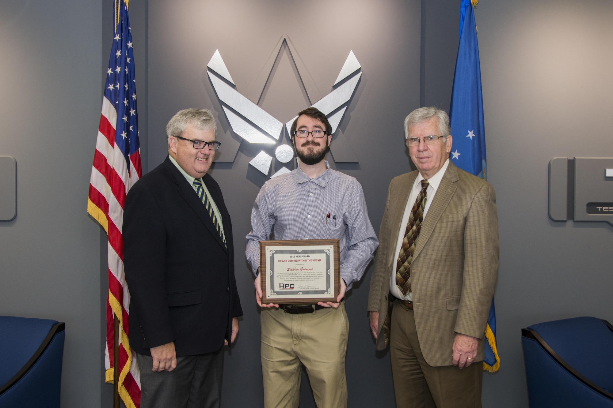 AEDC Scientist and Engineer Stephen Guimond (center) accepts the 2016 Hero Award for the Up and Coming within the Department of Defense High Performance Computing Modernization Program, or HPCMP, from Dr. Kevin Newmeyer (left), chief of staff of the DOD HPCMP, Oct. 17, 2016. Accompanying Guimond is the Air Force Test Center, AEDC Chief Technologist Dr. Edward Kraft. (U.S. Air Force photo/Jacqueline Cowan)