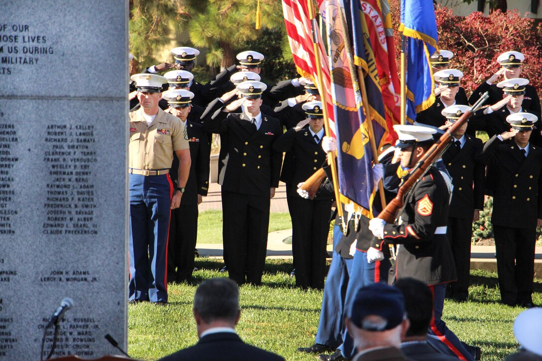 Marines and midshipmen salute as the San Diego State University ROTC Color Guard parades the colors before a wreath-laying ceremony at the War Memorial on Aztec Green at San Diego State University, San Diego, Nov. 4, 2016. Navy photo by Lt. Matthew Stroup