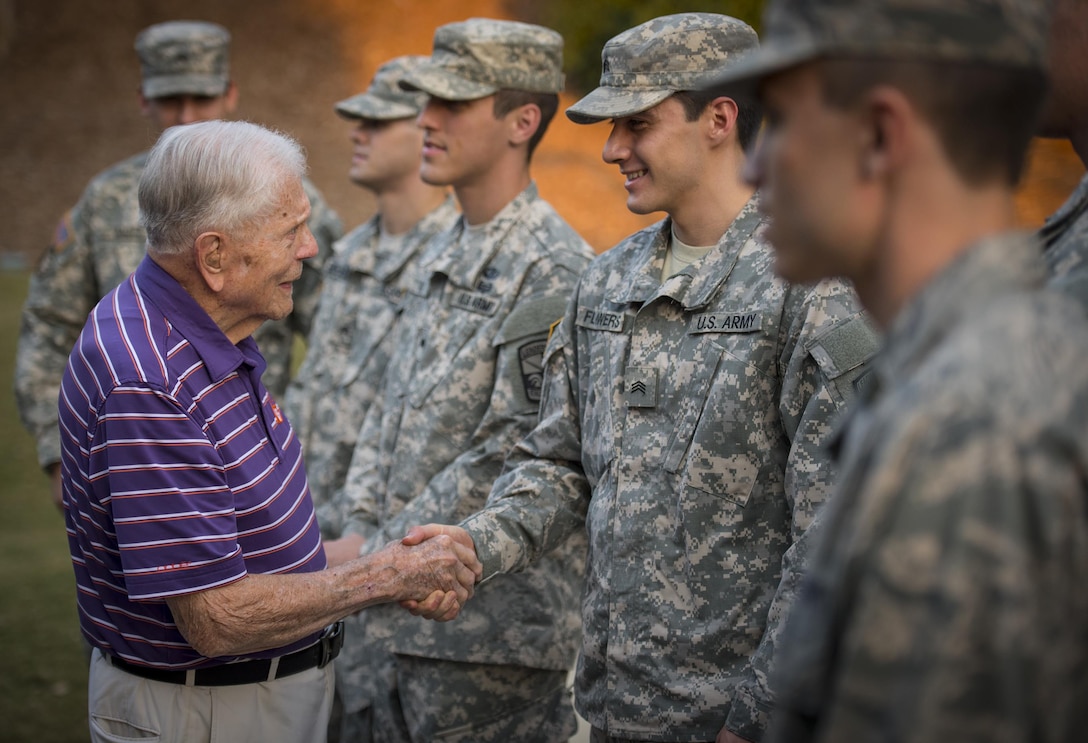 Clemson Univeristy professor emeritus, alumnus, and WWII hero Ben Skardon, 99, a survivor of the Bataan Death March, greets ROTC cadets who came to place flags around the Scroll of Honor for Military Appreciation Day, Nov. 3, 2016.  (U.S. Army photo by Staff Sgt. Ken Scar)