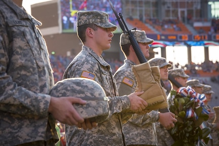 Cadets with Clemson University’s Reserve Officers’ Training Corps honor guard prepare to erect a Fallen Soldier Battle Cross on the field of Memorial Stadium during a ceremony at half time of the Military Appreciation Game, Nov. 5, 2016. (U.S. Army photo by Staff Sgt. Ken Scar)