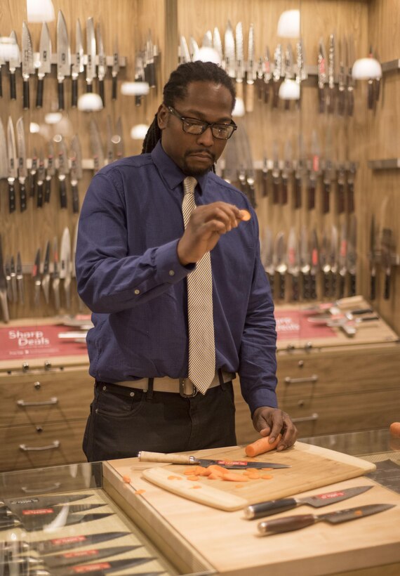 Veteran Reginald "Reggie" Des’Ravines examines cut of carrot as he shops for the perfect culinary utensils during his VIP shopping experience at Sur La Table, Charlotte N.C. Reggie received a VIP shopping experience and the opportunity to serve distinguished guests with his personal menu at The Fig Tree restaurant, Oct 27. (U.S. Army Reserve Photo by Spc. Tynisha L. Daniel, 108th Training Command (IET), Public Affairs)