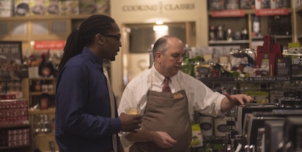 Veteran Reginald "Reggie" Des’Ravines accompanied by Assistant Manager Paul Close discuss espresso machines during his VIP shopping experience at Sur La Table, Charlotte N.C. Reggie received a VIP shopping experience and the opportunity to serve distinguished guests with his personal menu at The Fig Tree restaurant, Oct 27. (U.S. Army Reserve Photo by Spc. Tynisha L. Daniel, 108th Training Command (IET), Public Affairs)